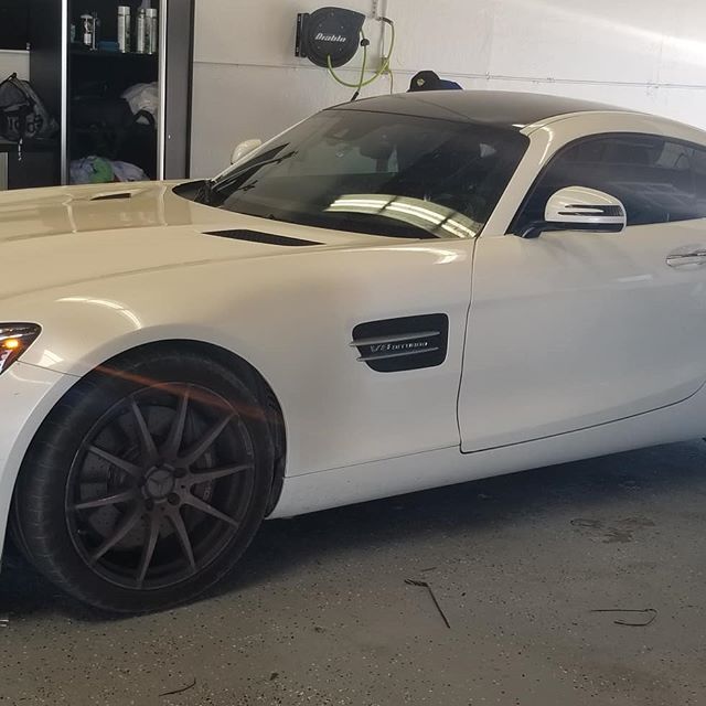 White mercedes AMG coupe with window tint