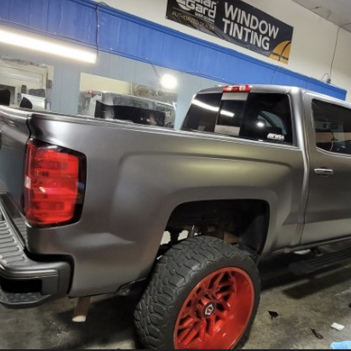 Truck with red rims wrapped in auto gray