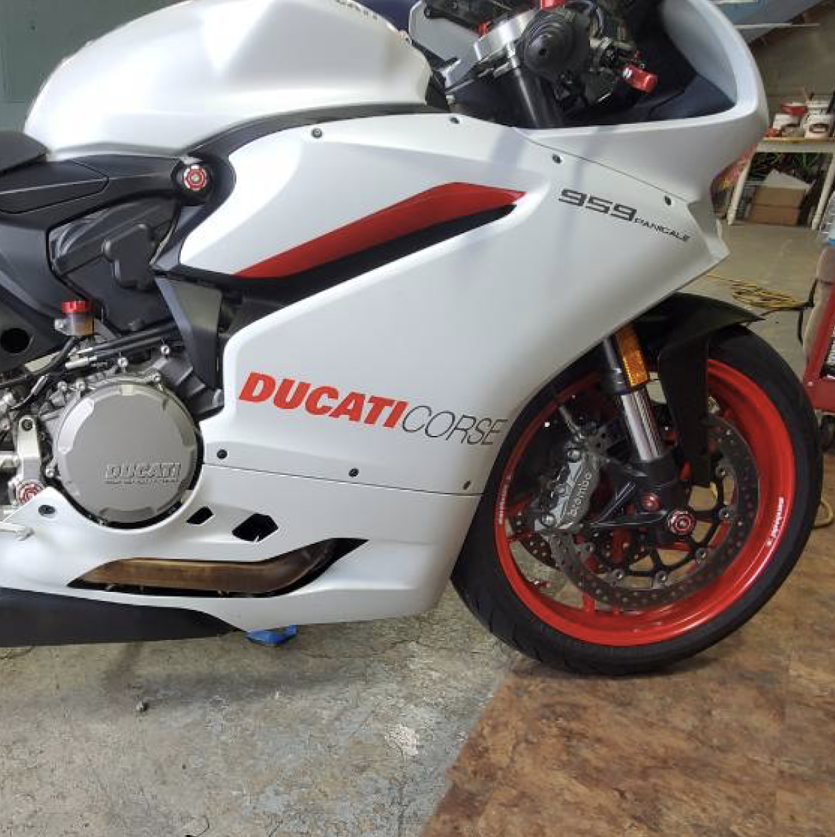 White Ducati corse with a partial wrap